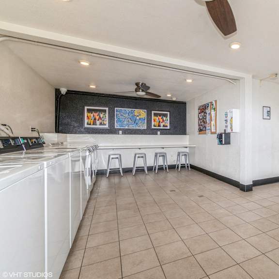 a kitchen with white appliances and a fan on the ceiling at oak center apartments, california