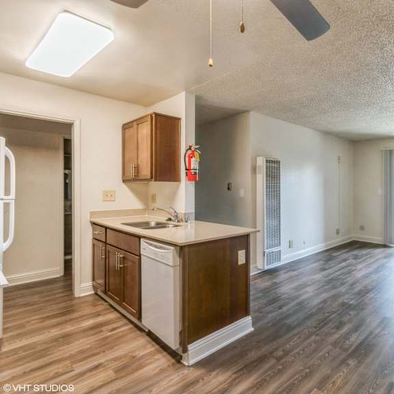 a kitchen with wood floors and a white countertop at oak center apartments, oakland, ca, 94607