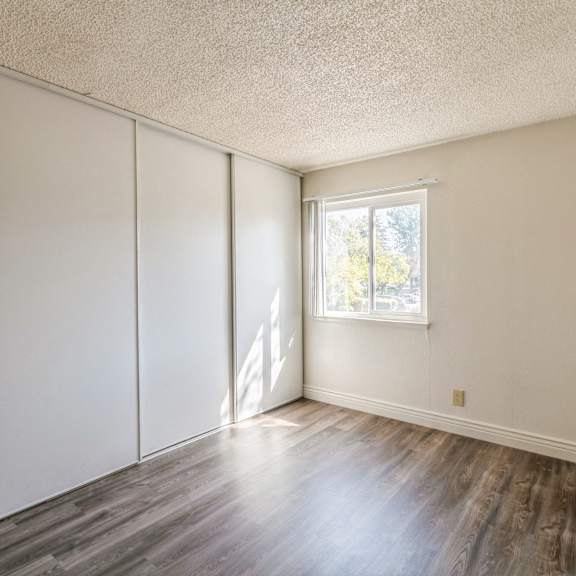 a room with a window and wooden floors at oak center apartments, oakland, california