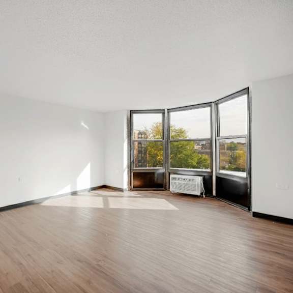a room with wooden floors and white walls at fullerton court apartments, chicago, 60614