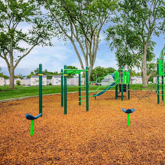 a playground with a green slide and a blue slide at poplar place apartments, springfield