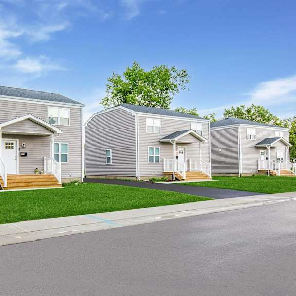 a row of houses with a driveway in front at poplar place apartments, springfield