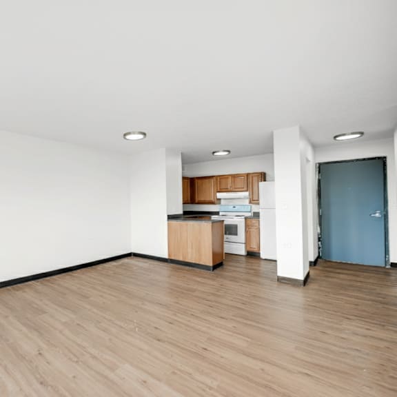 a room with wooden floors and white walls at fullerton court apartments, illinois