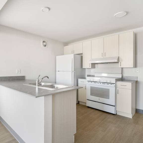 a kitchen with white appliances and wooden floors at poplar place apartments, springfield, il