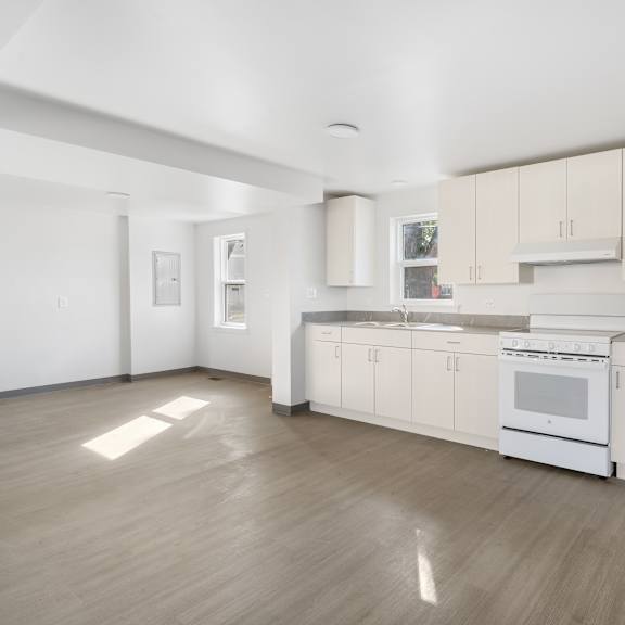 a white kitchen with wood floors and white appliances at poplar place apartments, springfield, 62703