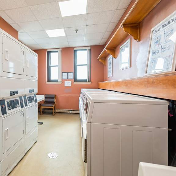 a laundromat with washers and dryers at mohican apartments, new london, ct