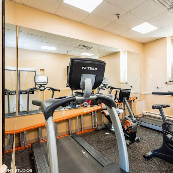 a gym with treadmills and elliptical machines. at mohican apartments, new london, connecticut