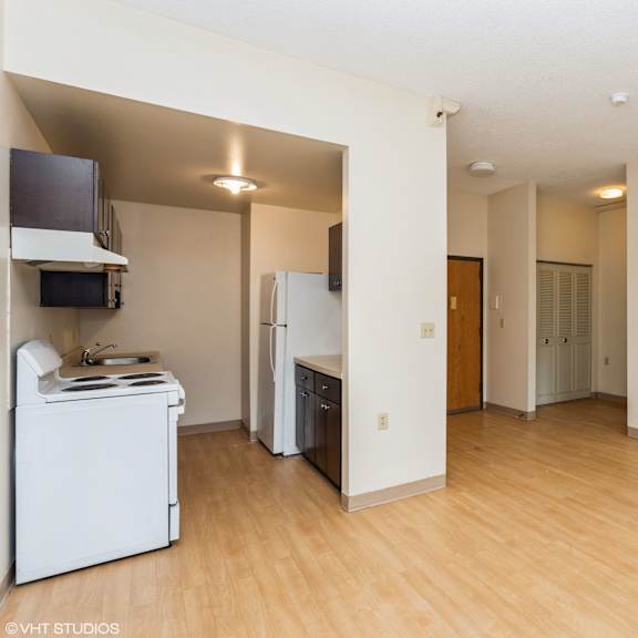 a kitchen with a refrigerator, microwave, and oven at mohican apartments, new london, ct