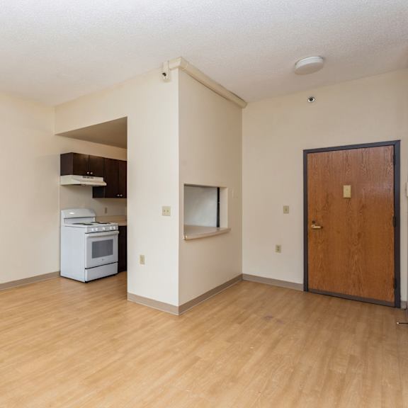 a kitchen area with a white oven and wooden door at mohican apartments, new london, ct, 06320