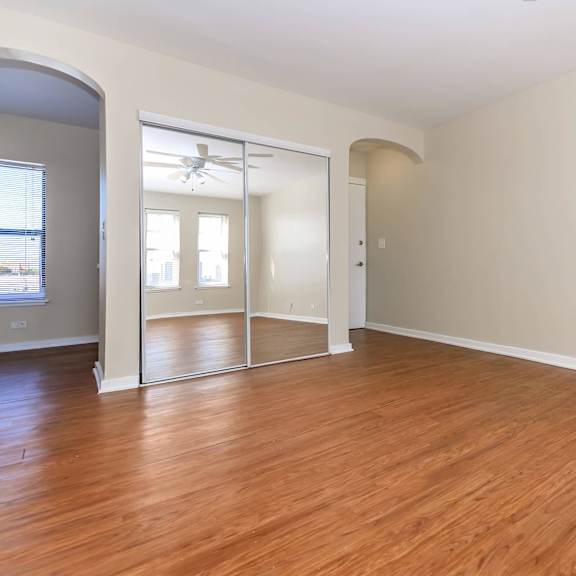 a room with wooden floors and a large mirror at sheridan park, illinois