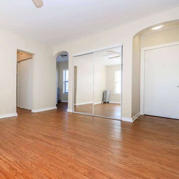 an empty room with wooden floors and a large mirror on the wall at sheridan park, chicago, il 60640