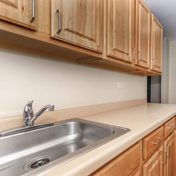 a kitchen with wooden cabinets and a white refrigerator at sheridan park, illinois
