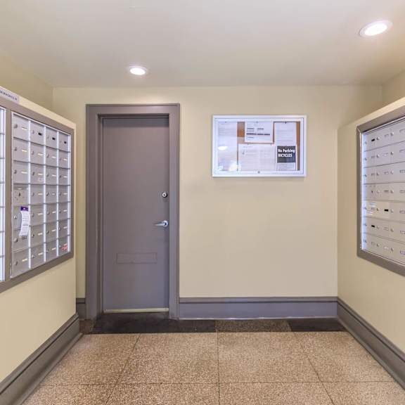 a hallway with a wall of mailboxes at sheridan park, chicago