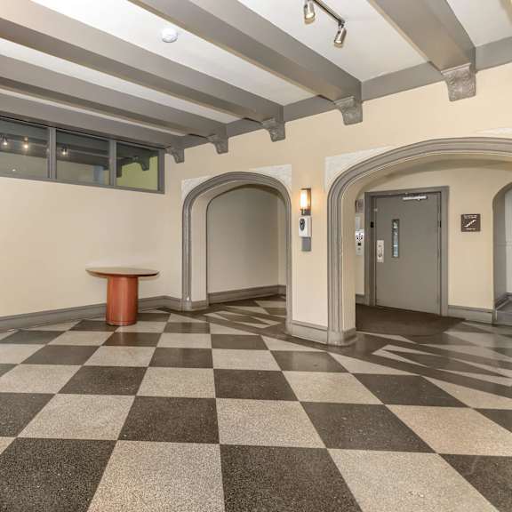 a hallway with a checkered floor and a brown carpet at sheridan park, chicago, illinois