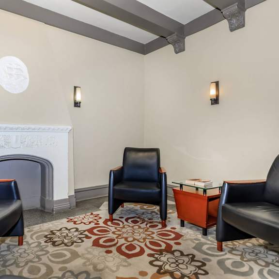 a living room with a fireplace and leather chairs at sheridan park, chicago, il