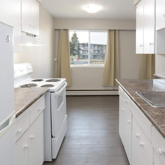 a kitchen with white appliances and cabinets.