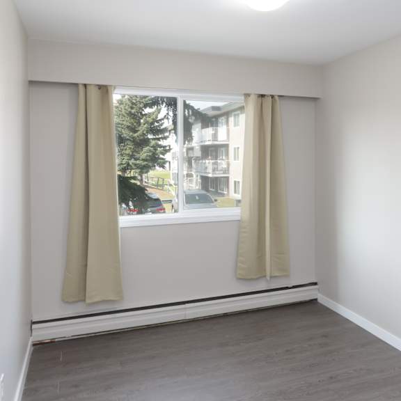 a room with a window and curtains.