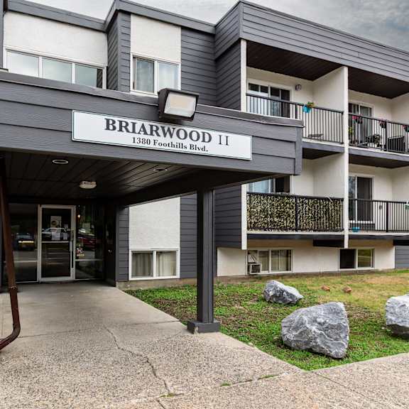 the entrance to a building named briarwood 11 with a walkway leading to the door.