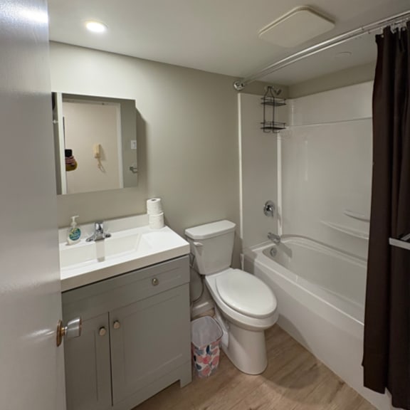 a bathroom with a toilet, sink, and bathtub.