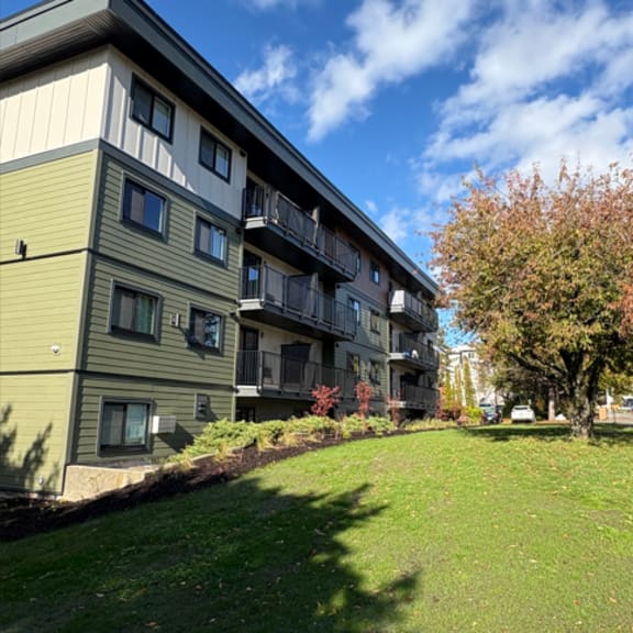 a building with a green lawn in front of it.