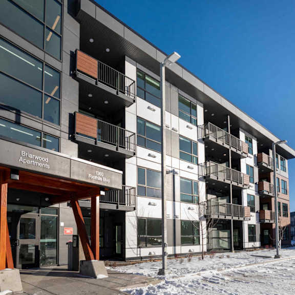 a large building with the words "birchwood apartments" on the front entrance.