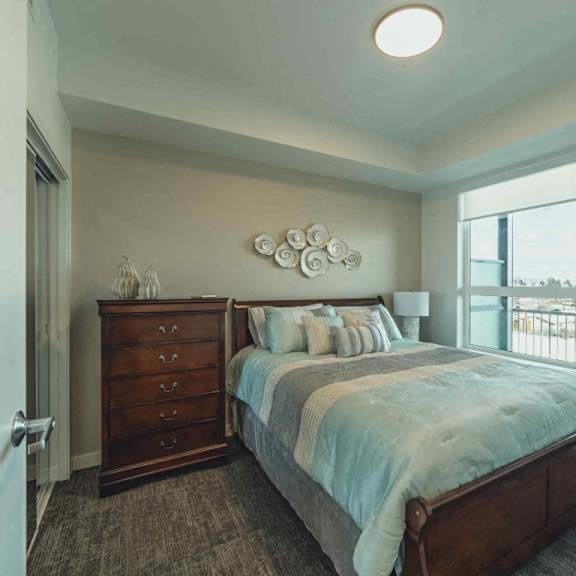 a bedroom with a large bed and a dresser with a mirror above it.