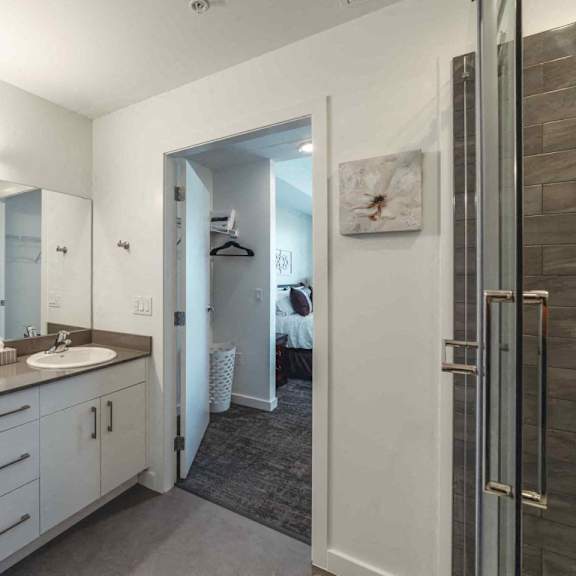 a bathroom with a double sink vanity and a mirror above it.