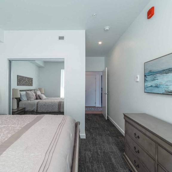 a bedroom with a large bed and a painting on the wall.