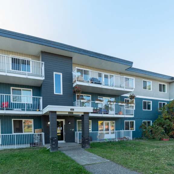 a building with a blue and white exterior and a balcony.