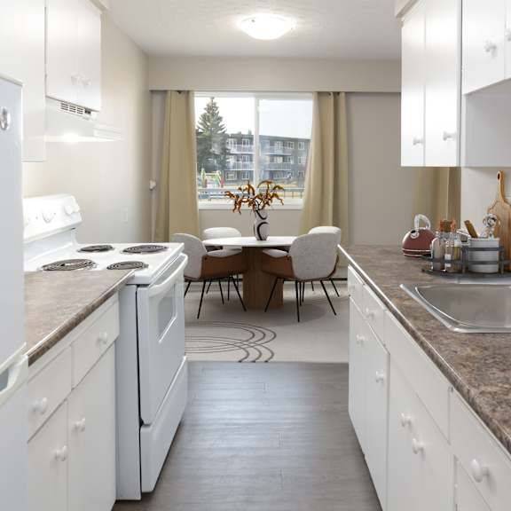 a kitchen with white cabinets and a marble countertop.