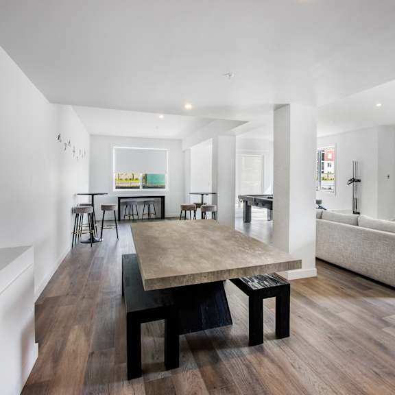 a modern living room with a wooden floor and white walls.