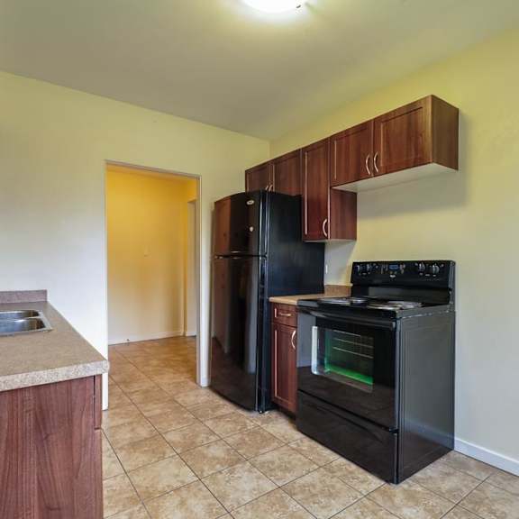 a kitchen with a black oven and a sink.