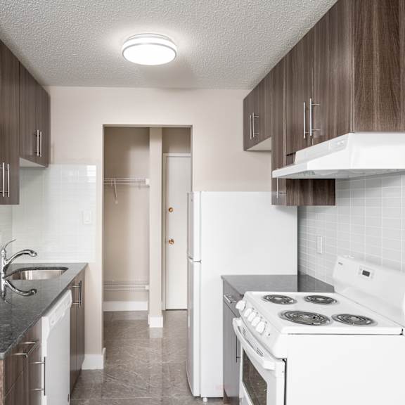 a kitchen with a white stove and a white refrigerator.