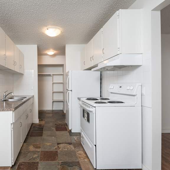 a kitchen with white appliances and cabinets.