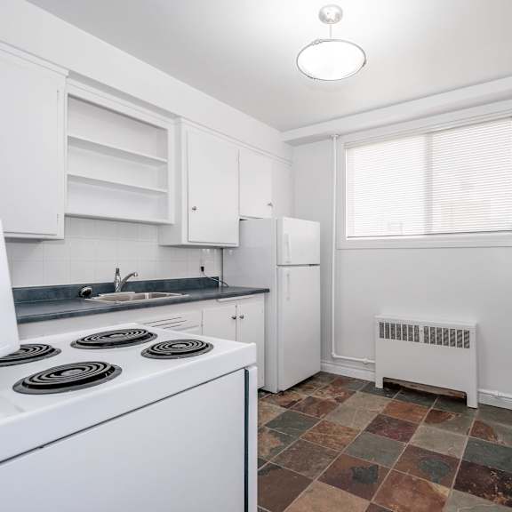 a kitchen with white appliances and cabinets.