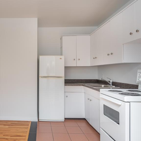 a kitchen with white appliances and cabinets.