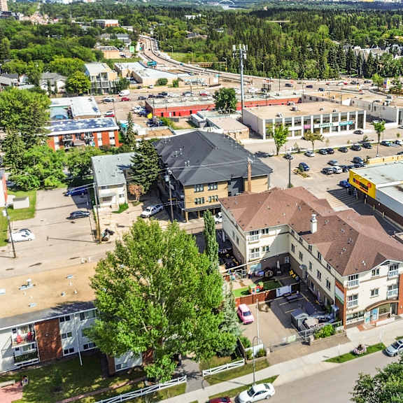 a parking lot is surrounded by buildings in the image.