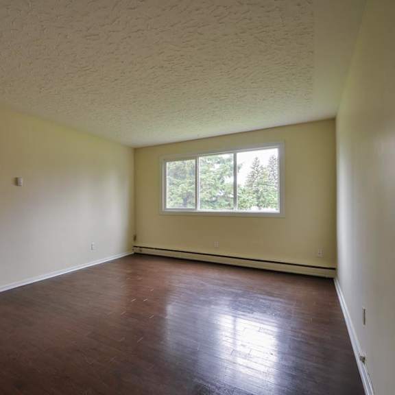 a room with a wooden floor and a window.