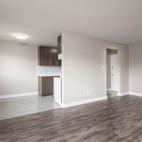 a room with wooden flooring and a cabinet in the corner.