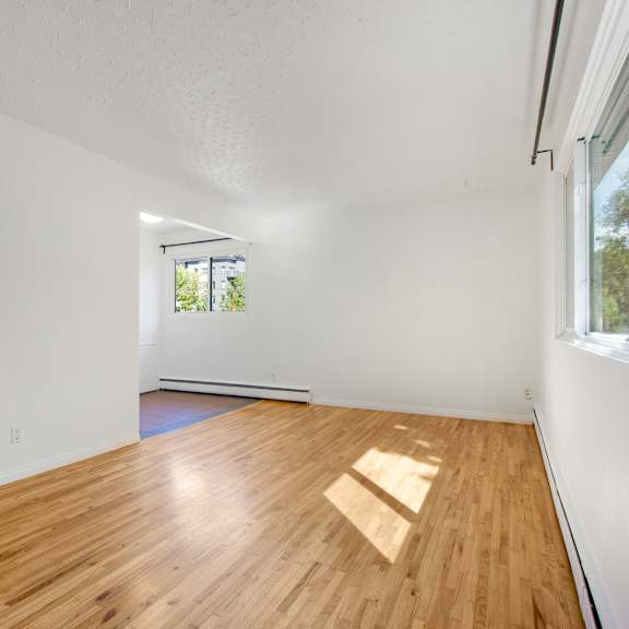 a room with wooden flooring and a window.