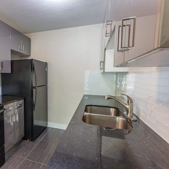 a kitchen with black appliances and a black oven.