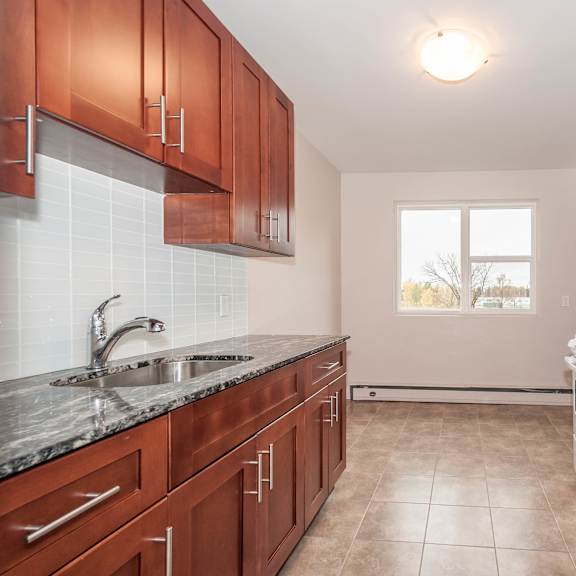 a kitchen with brown cabinets and a white refrigerator.