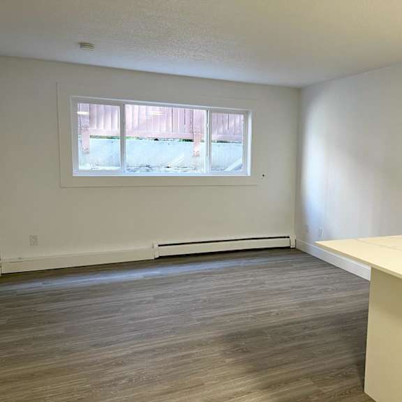 a room with a window and a white desk.