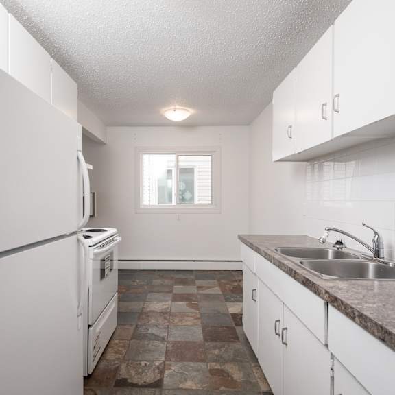 a kitchen with white appliances and cabinets.