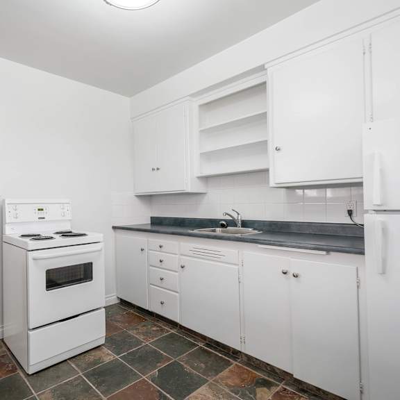 a kitchen with white appliances and cabinets.