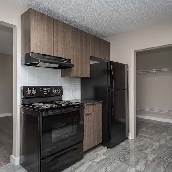a kitchen with a black stove top oven and black refrigerator.