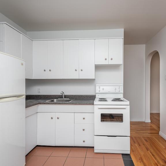 a kitchen with white appliances and cabinets.