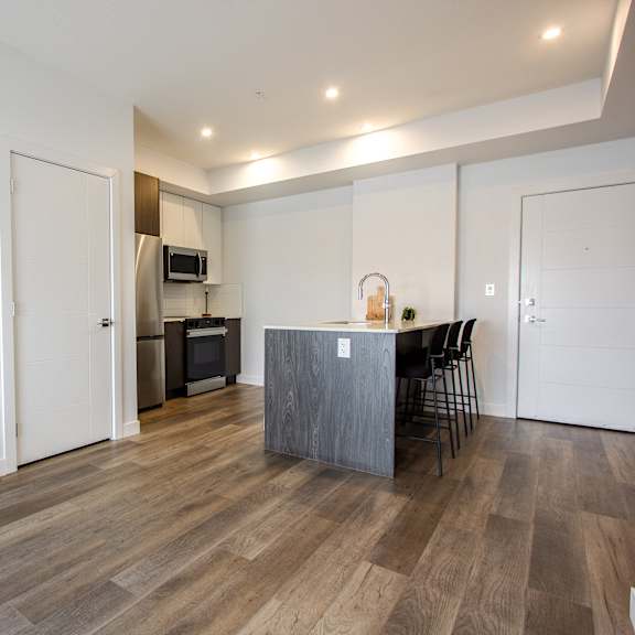 a kitchen with a table and chairs in the middle of the room.