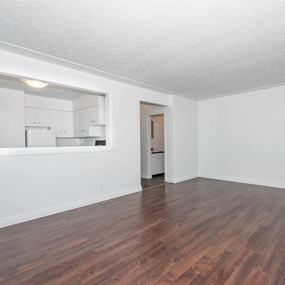 a room with wooden floors and white walls.