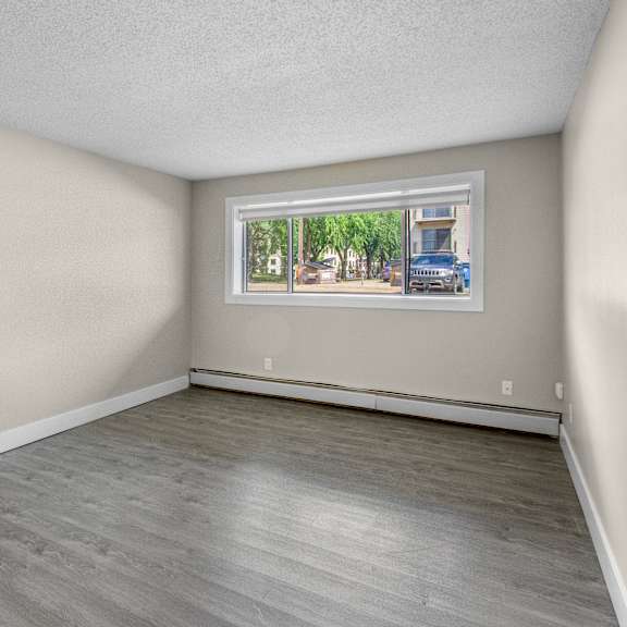 empty room with a window showing a street view.